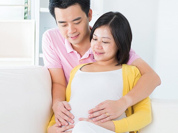 A husband comforting a pregnant mother experiencing pregnancy fatigue