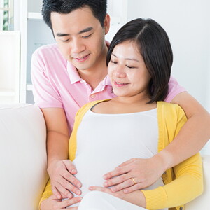 A husband comforting a pregnant mother experiencing pregnancy fatigue